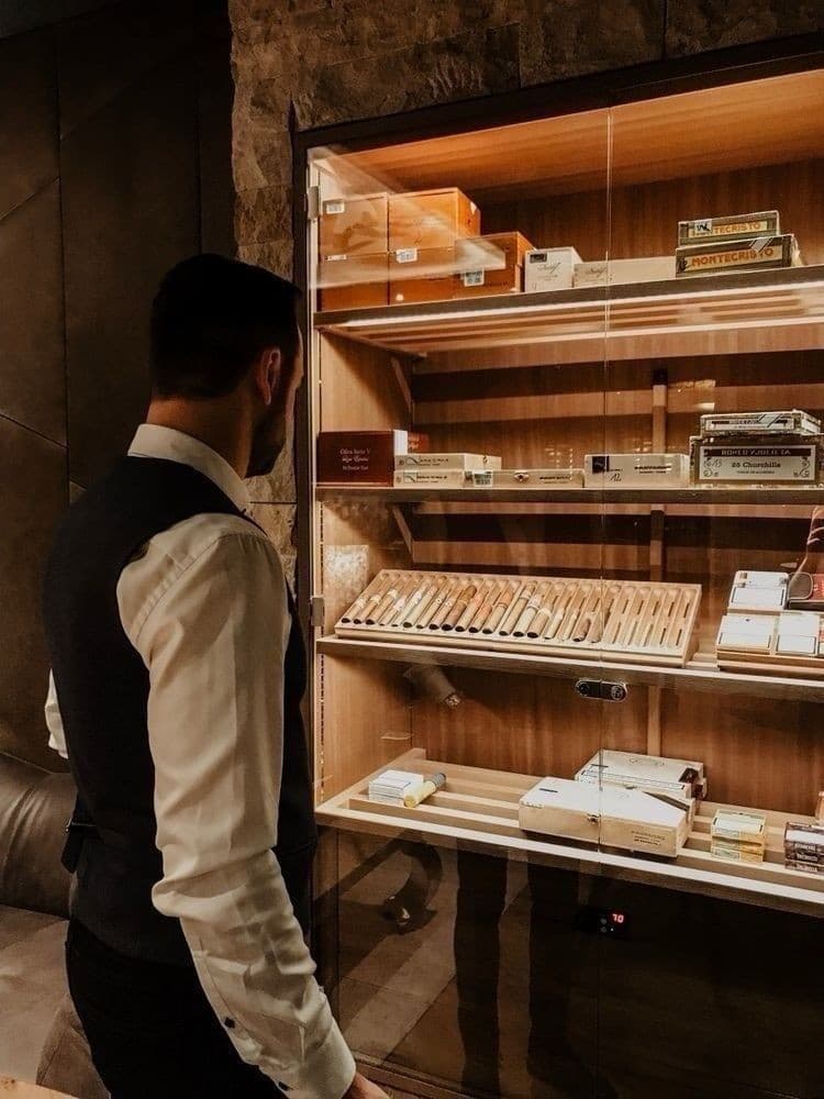 A collector reviewing the boxes inside a humidor