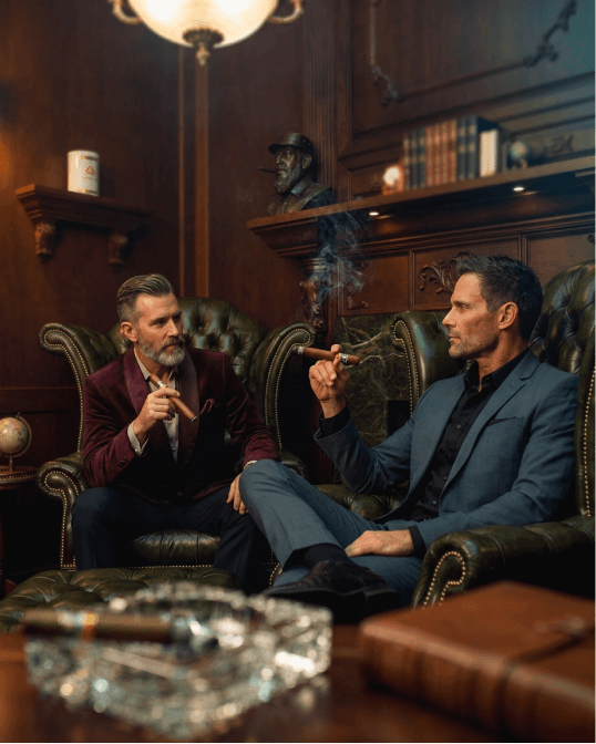 Two collectors enjoying cigars in a members lounge